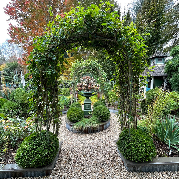 Arbor leading from the woodland garden to the vegetable/ flower garden.